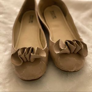 Taupe Flats with “flower” over the toes.
